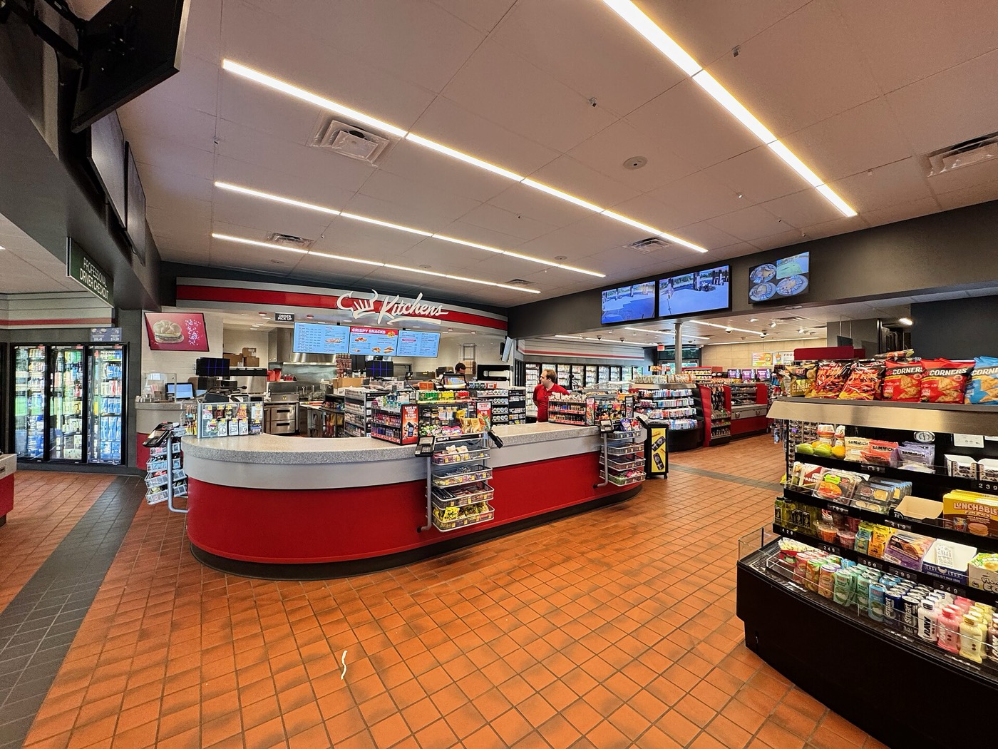 Торговый зал магазина при АЗС QuikTrip: касса, кухня, витрины со снеками и напитками